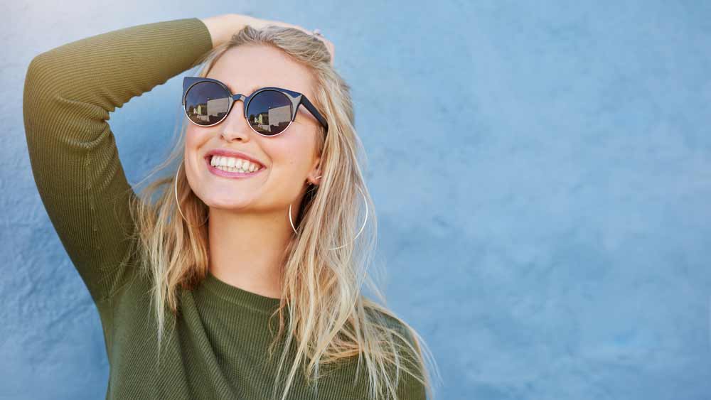 patient smiling after her porcelain veneer procedure