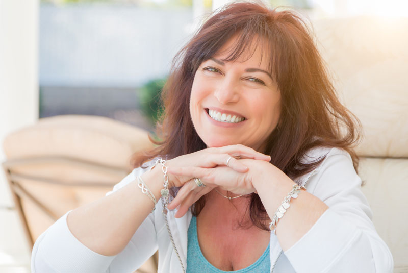 a dental patient smiling after her Invisalign treatment