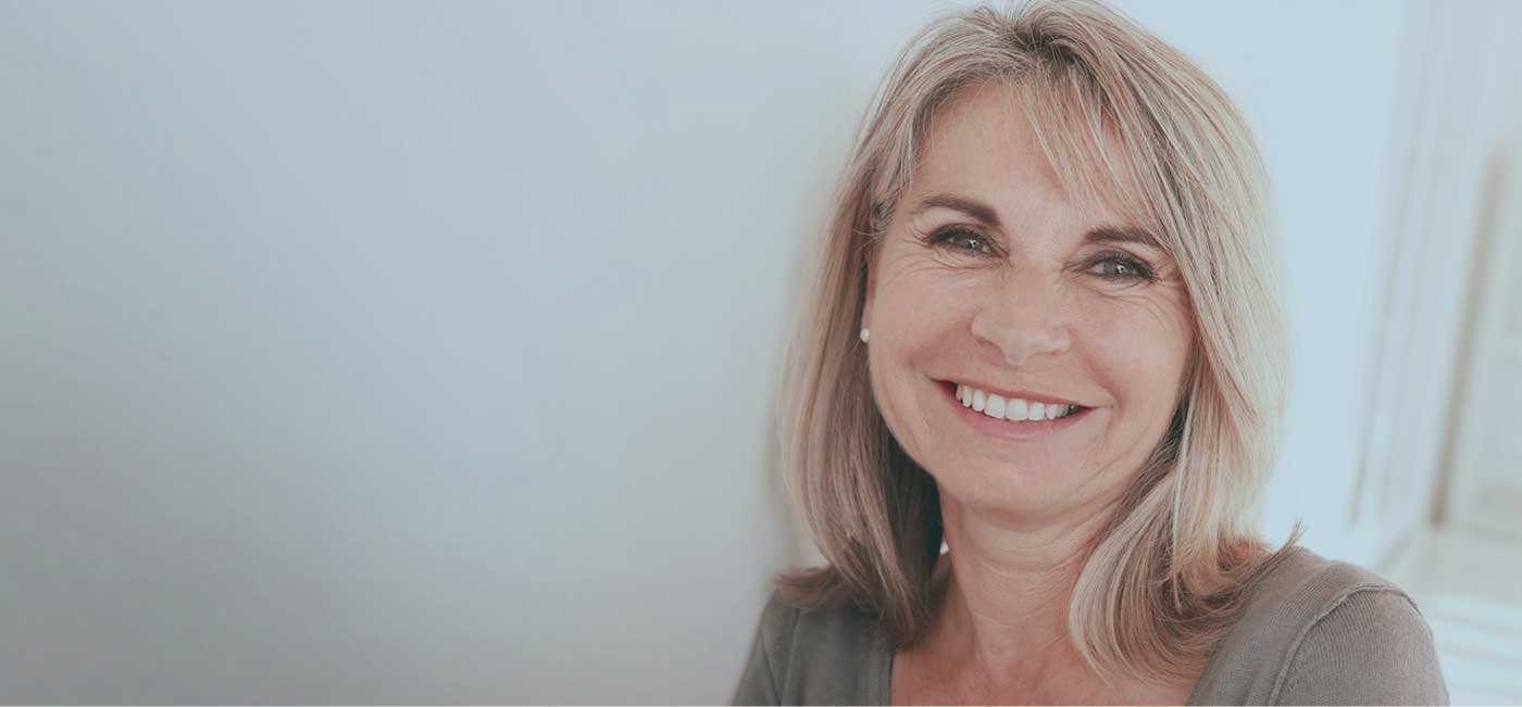 a patient smiling with her new dental implants