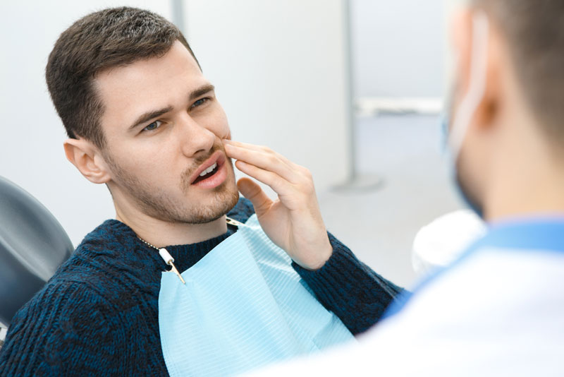 Dental Patient Suffering From Mouth Pain While In The Dental Chair