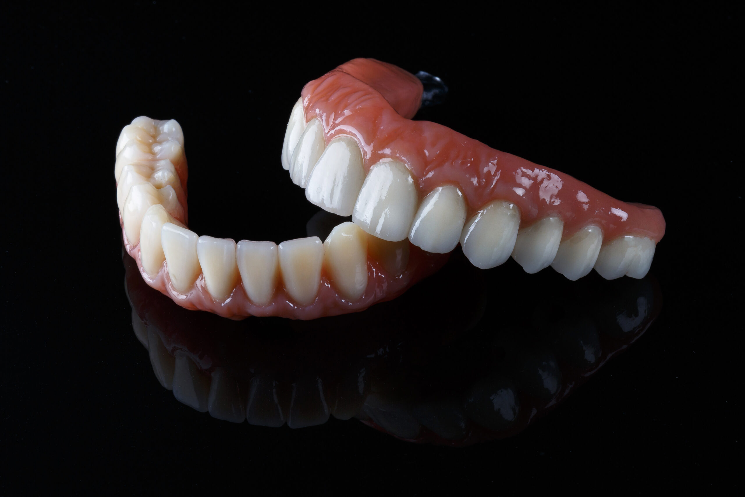 Close-up 3d model of two dentures in a black background
