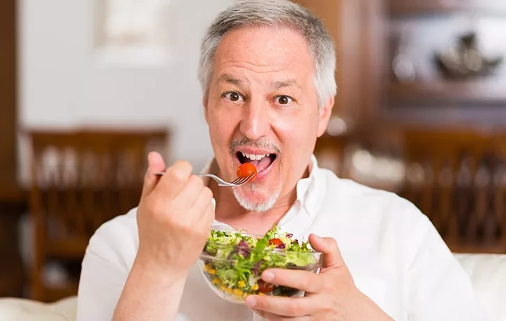 Enjoying food after Implant Supported Dentures miami beach florida.webp